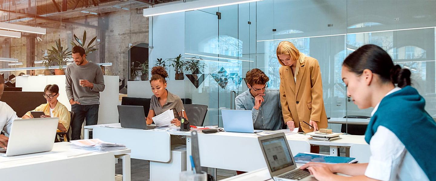 a group of people sitting in front of a laptop